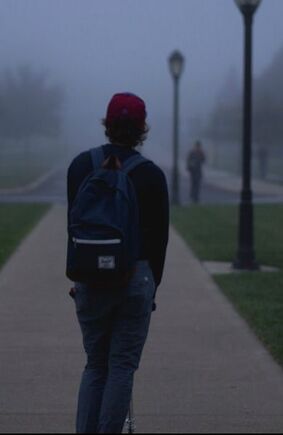 Teen with backpack on a foggy day. Depression and anxiety in the teen years
